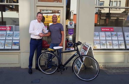 Smiles all round! Chris from Whitman & Co greets Manish, the winner of the cycle raffle
